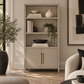 two door bookcase with three shelves in gray in a neutral decorated room