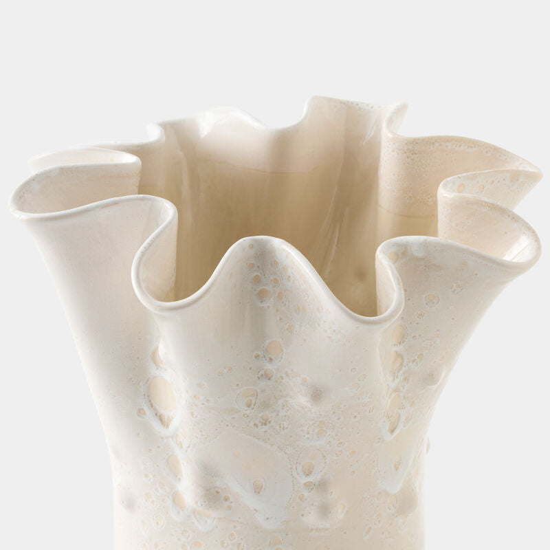 Beige ceramic vase with ruffled edges on a light gray background
