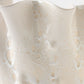 Close-up of a textured ceramic vase with a wavy design on a white background