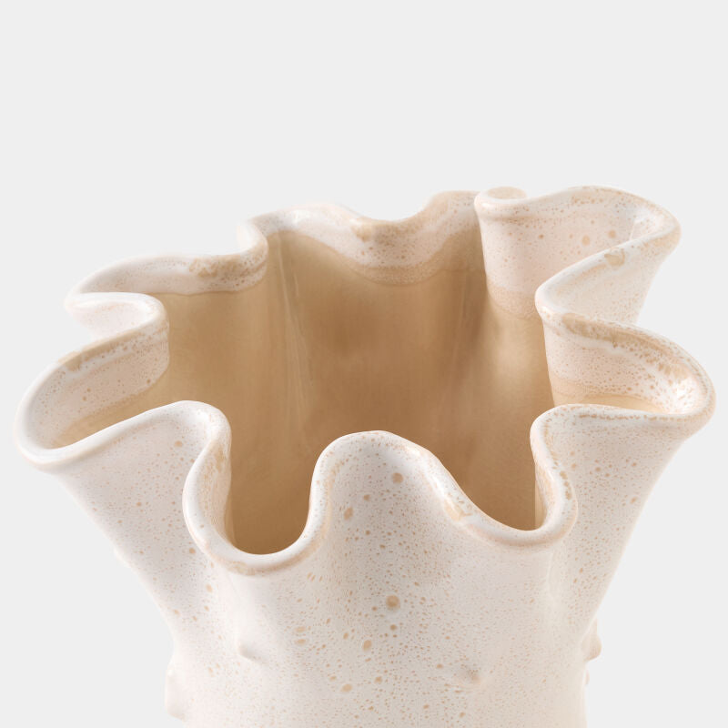 Beige ceramic vase with wavy edges on a white background