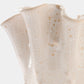 Close-up of a ceramic vase with a textured surface on a white background