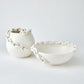 Two ceramic pots with chain-like designs on a white background