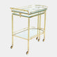 Gold-framed glass-topped serving cart on a white background