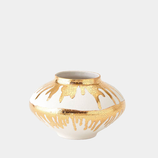 Decorative vase with gold and white design on a light gray background