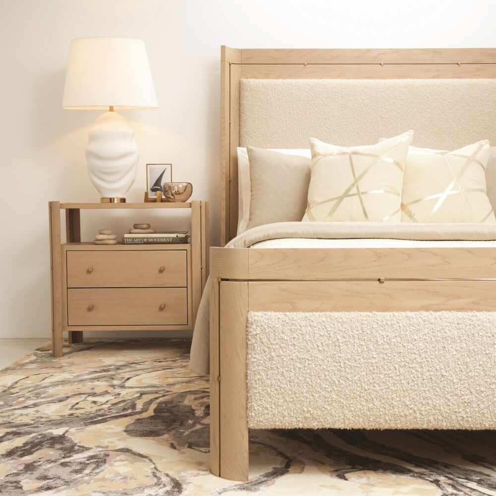 Wooden bed with upholstered headboard and nightstand in a bedroom setting.