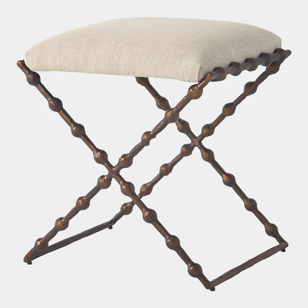 Stool with metal frame and beige cushion on a white background