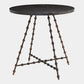 A round dark stone side table with a black marble top and a unique bronze-finished metal base featuring twisted, beaded legs and a crisscross lower support.