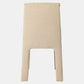 A minimalist upholstered stool with a tall rectangular backrest and integrated legs, upholstered in a textured beige linen fabric, shown against a plain white background.