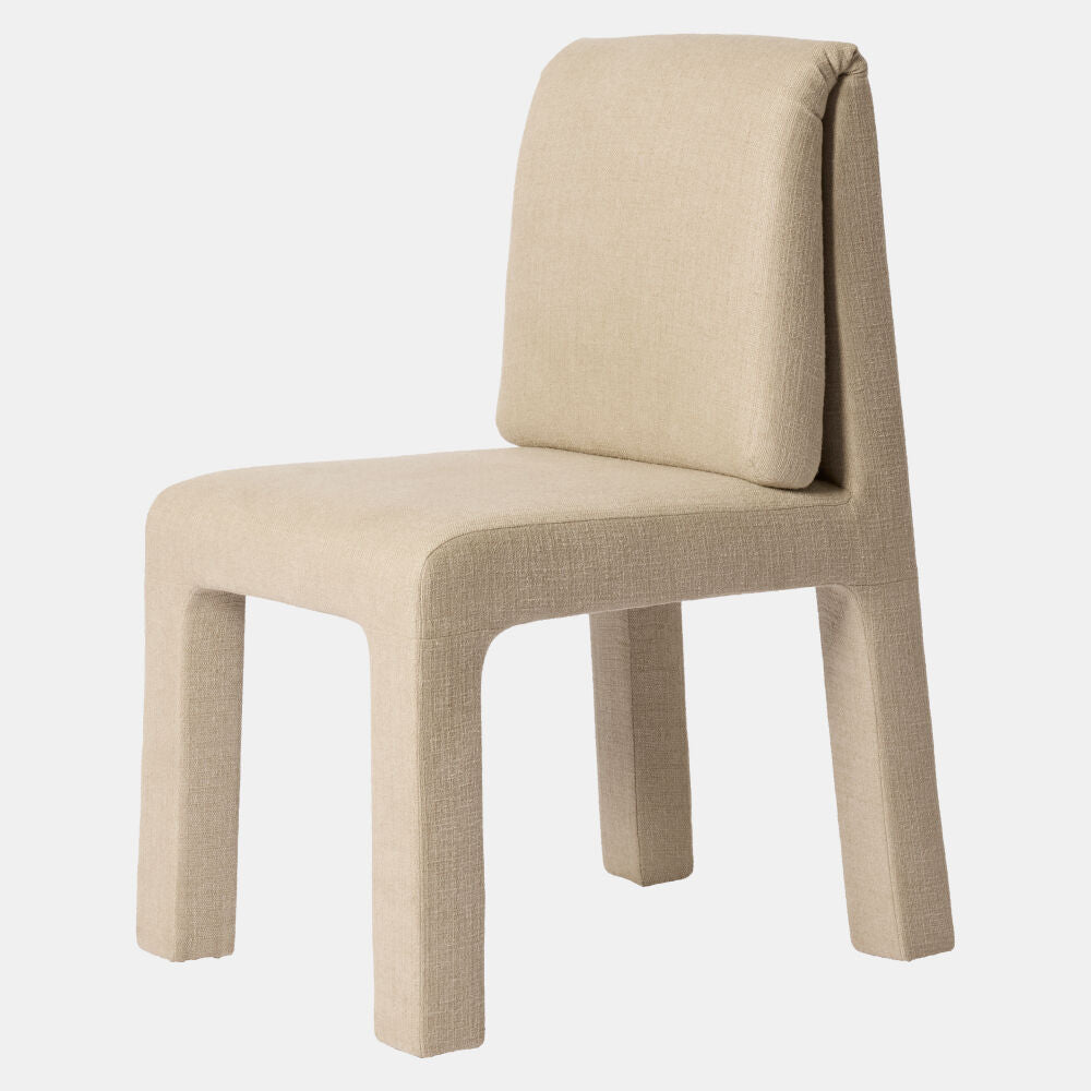A modern upholstered dining chair with a high backrest, featuring a thick seat cushion and four sturdy block legs, upholstered in a textured beige fabric, shown against a plain white background.