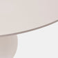 Close-up of a round table with a beige surface on a light gray background