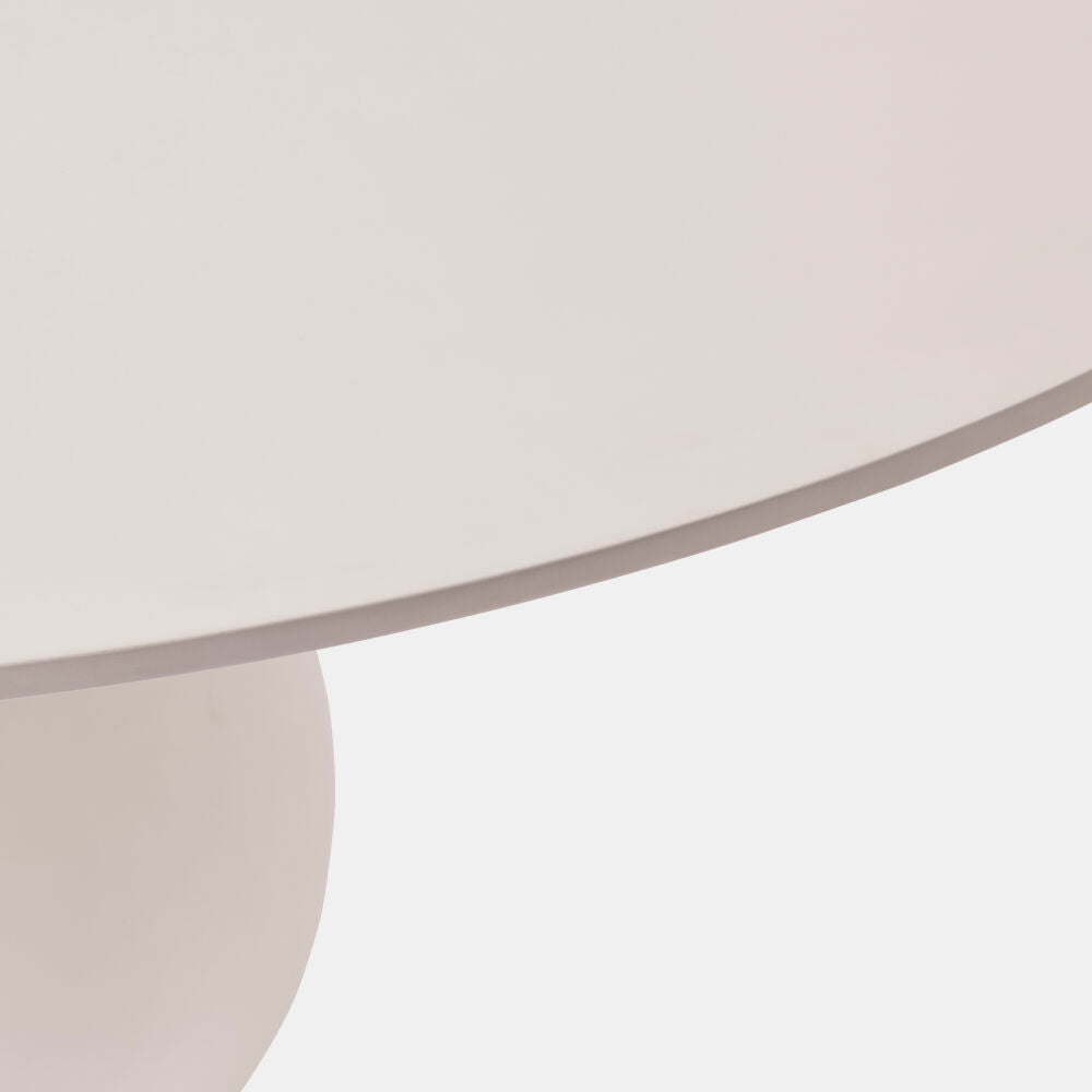 Close-up of a round table with a beige surface on a light gray background