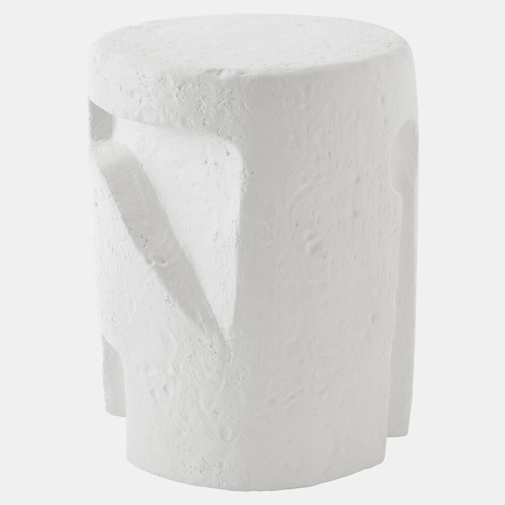 A white textured cylindrical stool with a sculptural, organic shape and recessed details, shown against a light gray background.