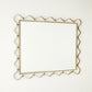 Decorative wall mirror with gold frame on a white background