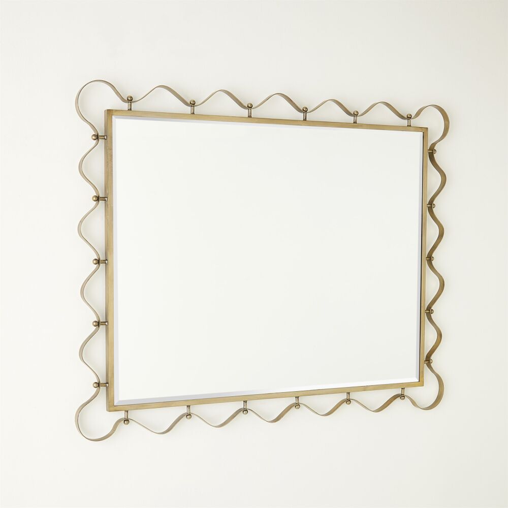 Decorative wall mirror with gold frame on a white background