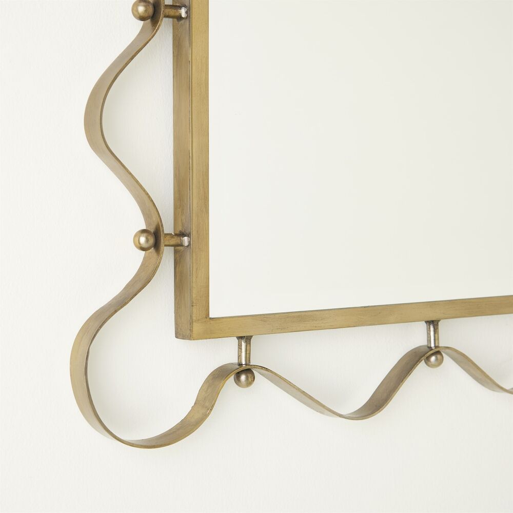 Decorative brass wall hook on a white background