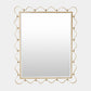 Decorative gold-framed mirror on a light gray background