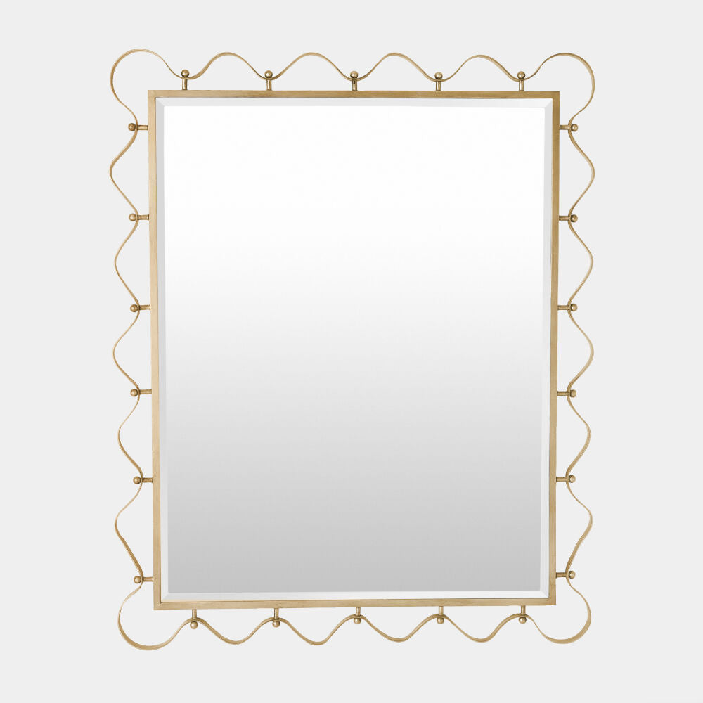 Decorative gold-framed mirror on a light gray background