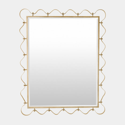Decorative gold-framed mirror on a light gray background