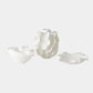Three white ceramic sculptures on a light gray background