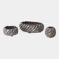 Set of three decorative metal bowls with textured surface on a white background