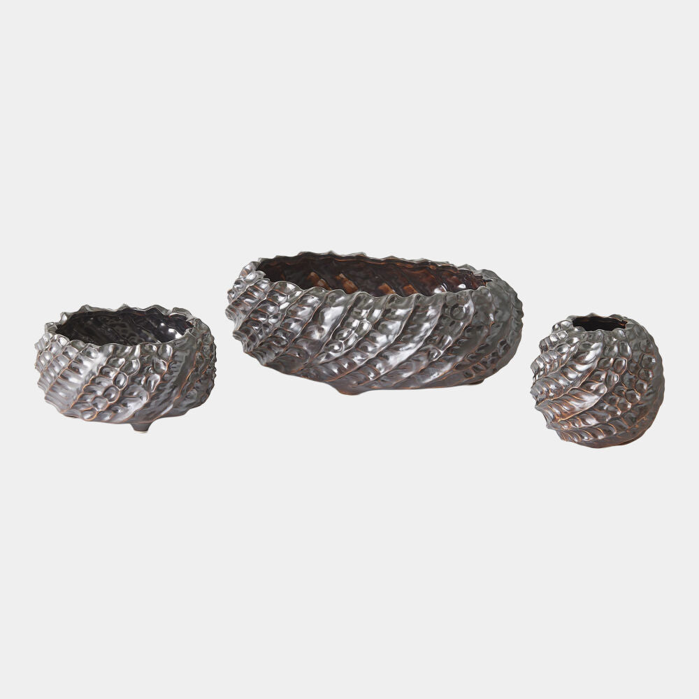 Set of three decorative metal bowls with textured surface on a white background