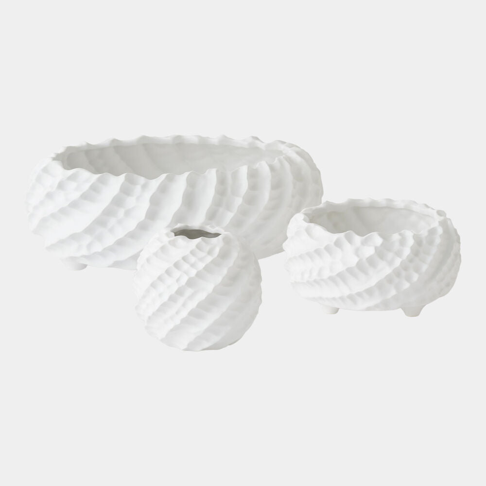 Two white ceramic bowls with textured surfaces on a light gray background