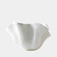 White ceramic bowl with textured surface on a light gray background