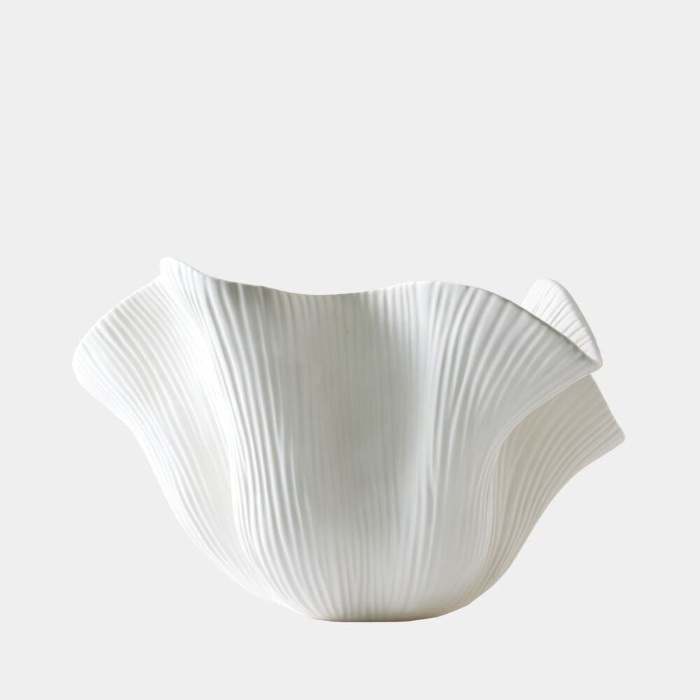 White ceramic bowl with textured surface on a light gray background