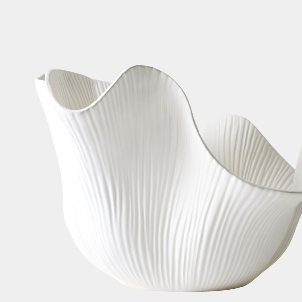 White ceramic bowl with wavy design on a light gray background