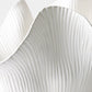 Close-up of a textured white ceramic plate with concentric circular patterns.