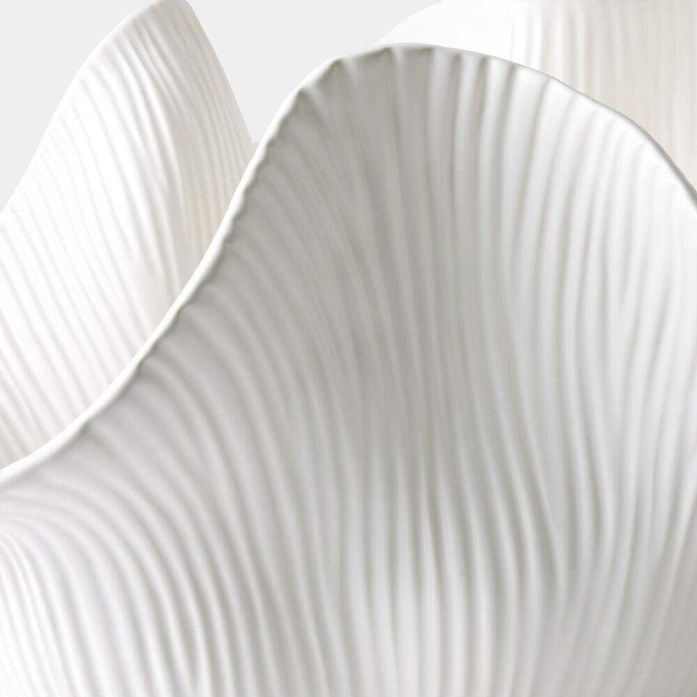 Close-up of a textured white ceramic plate with concentric circular patterns.