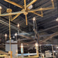Gold chandelier in a showroom with various furniture and decor items.