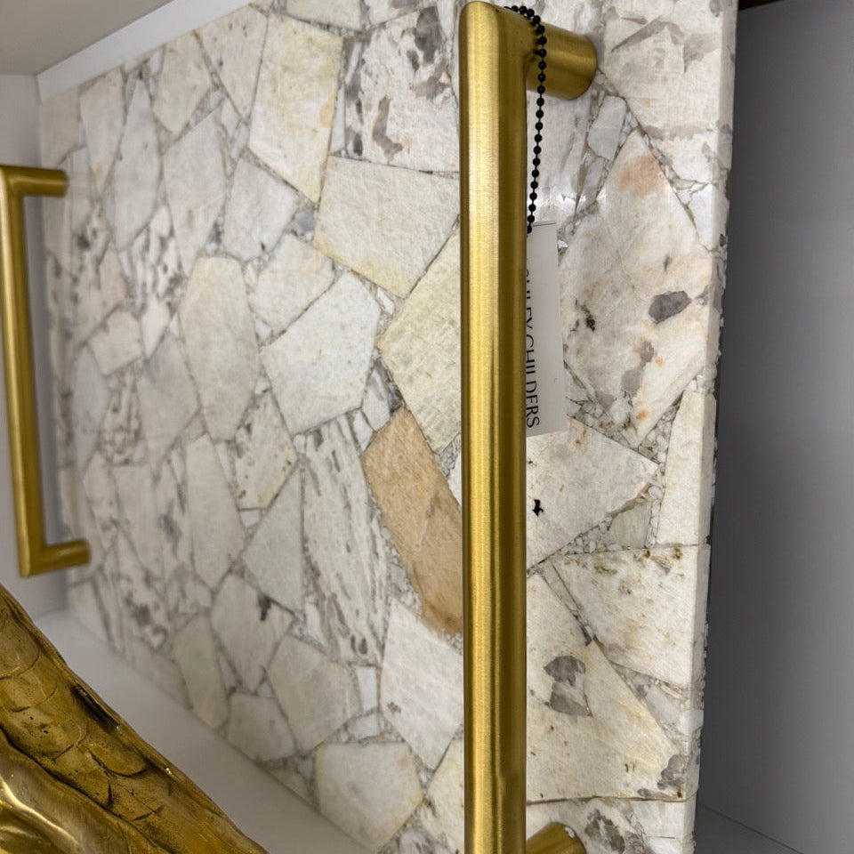 Gold handle on a marble door
