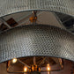 Close-up of a textured silver lampshade with a blurred background