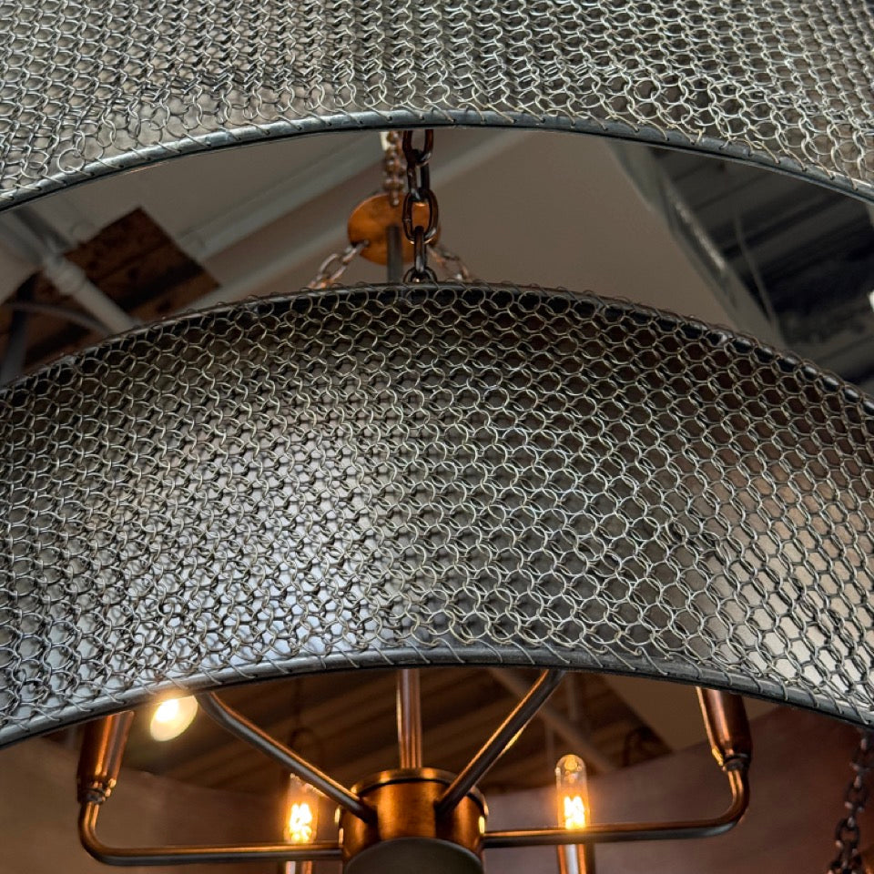 Close-up of a textured silver lampshade with a blurred background
