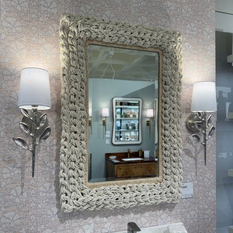 Decorative mirror with textured frame in a bathroom setting