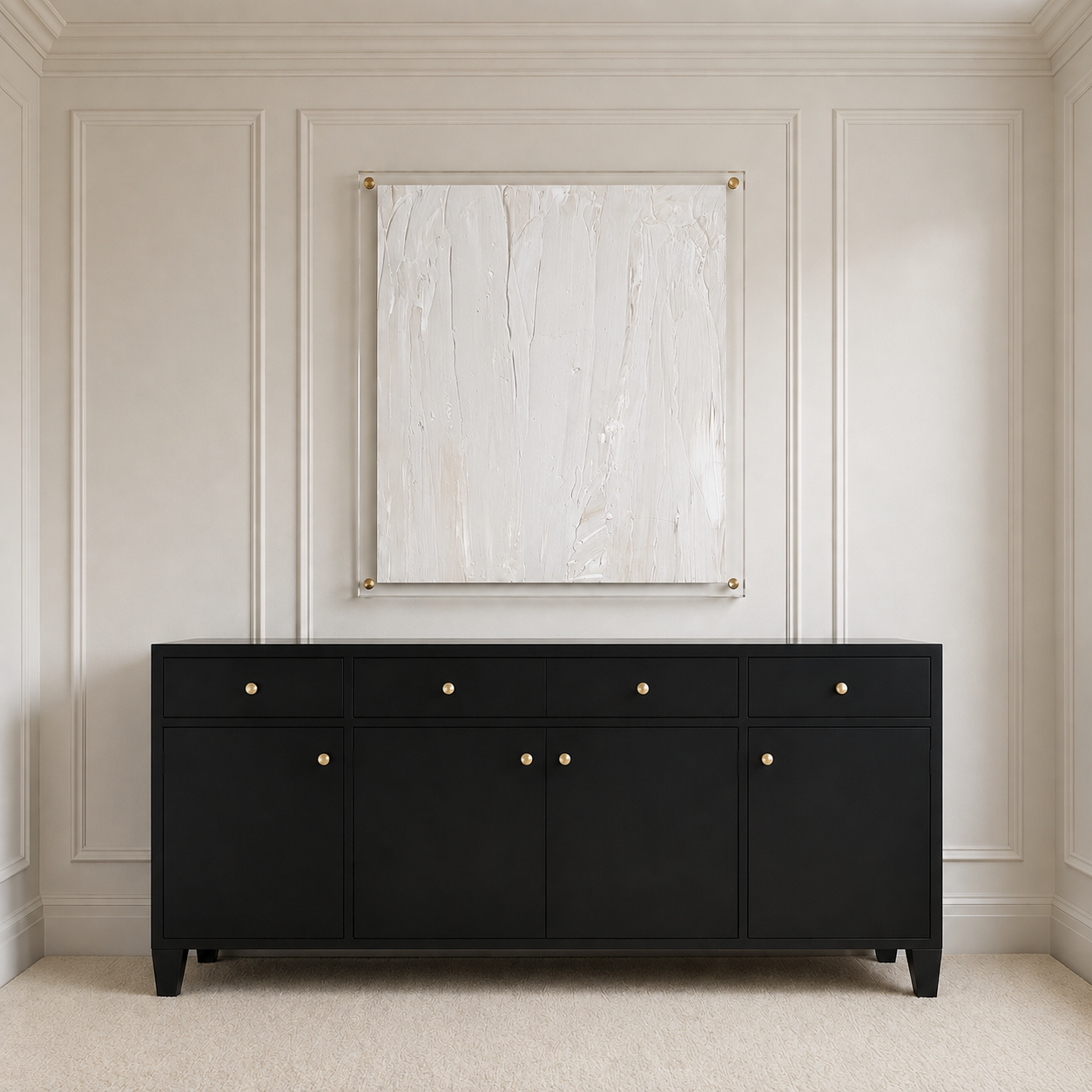 A black wooden sideboard or credenza with five drawers and three cabinet doors, each featuring a small round gold pull, set against a cream paneled wall with a framed abstract print above.