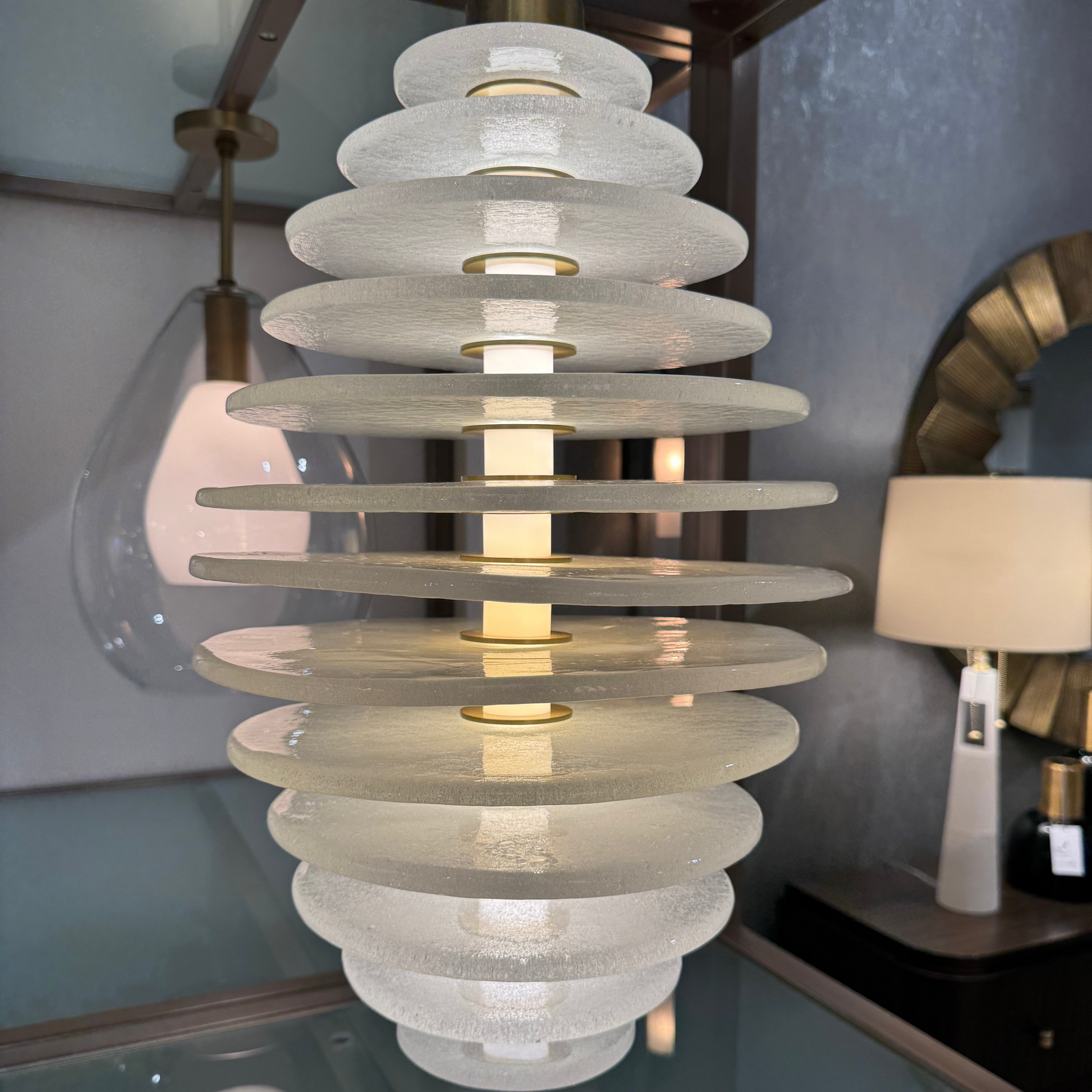Modern chandelier with layered design in a room setting