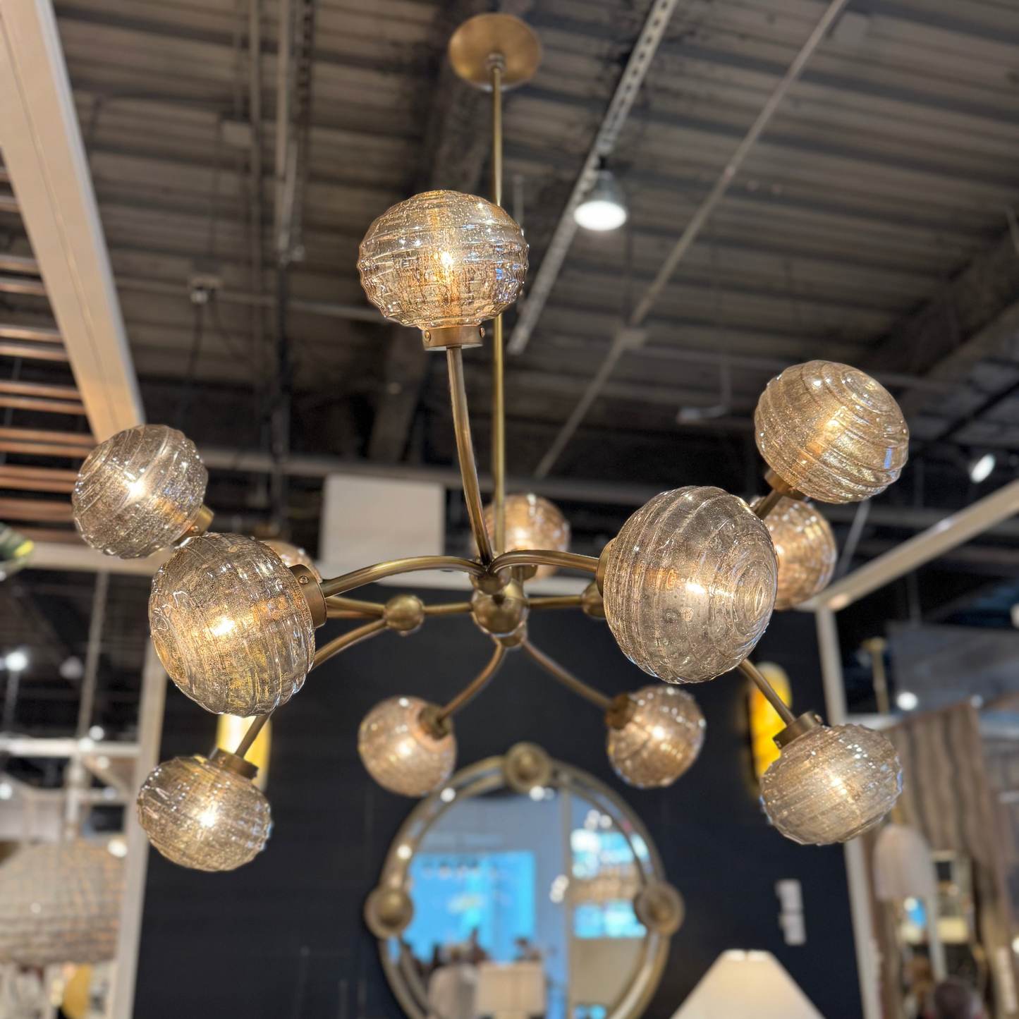 Chandelier with multiple round glass shades in a store setting