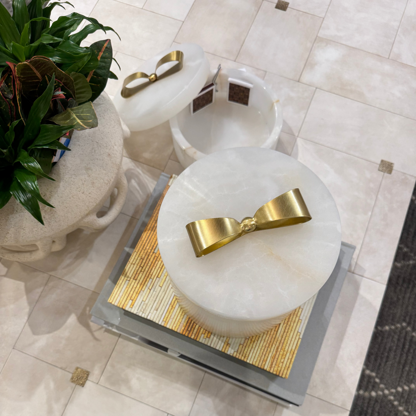 Decorative stone bowls with gold accents on a tiled floor