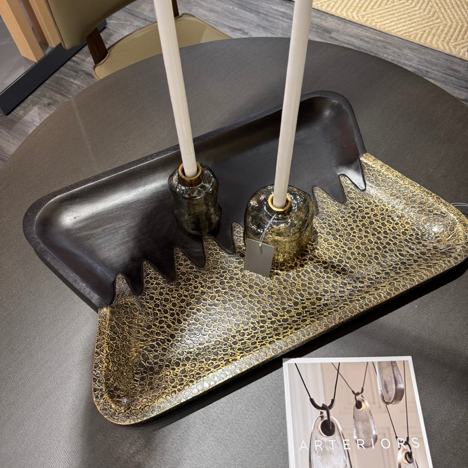 Decorative tray with jewelry on a table, next to a magazine with jewelry images.