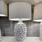 Decorative table lamp with textured base on a white surface