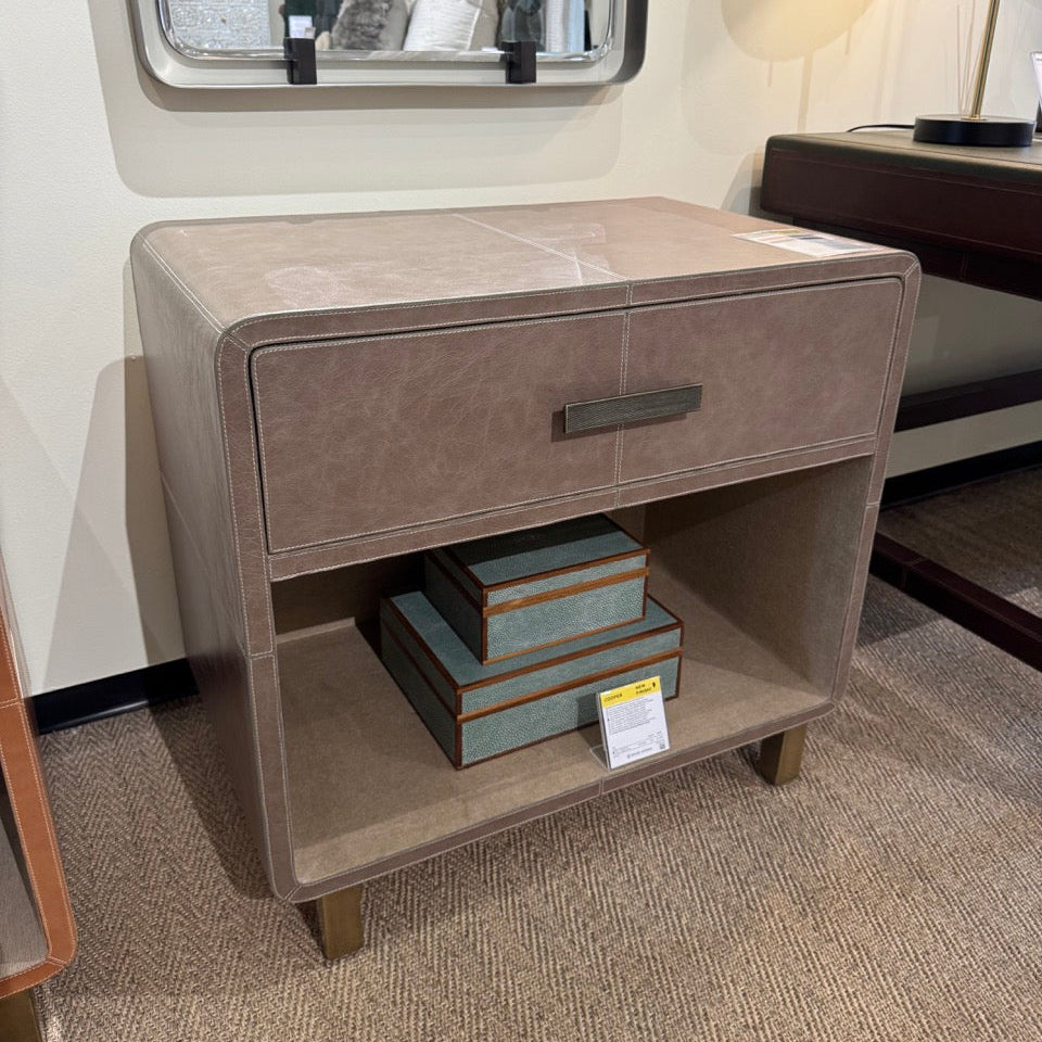 Beige nightstand with a mirror above it in a bedroom setting