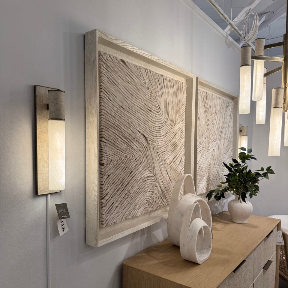 Modern interior design with wall art, light fixture, and decor items.