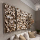 Decorative wall art with metallic elements above a sofa in a living room.