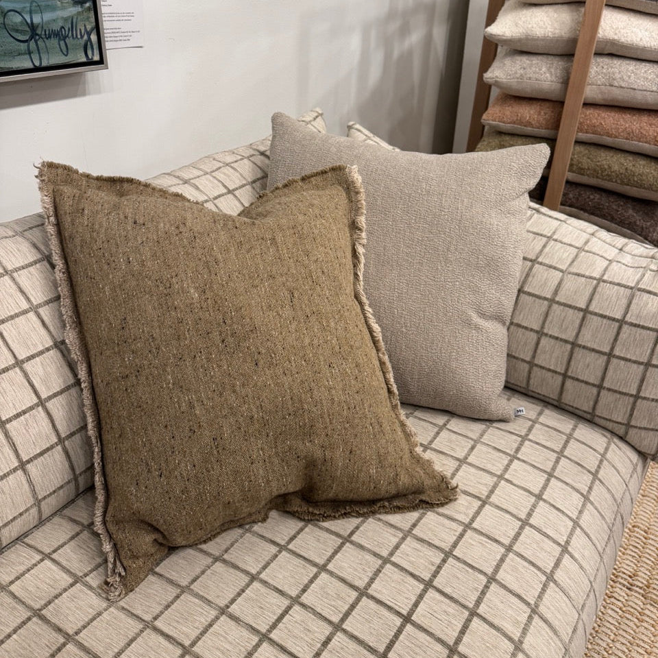 Textured pillows on a sofa with a neutral color palette