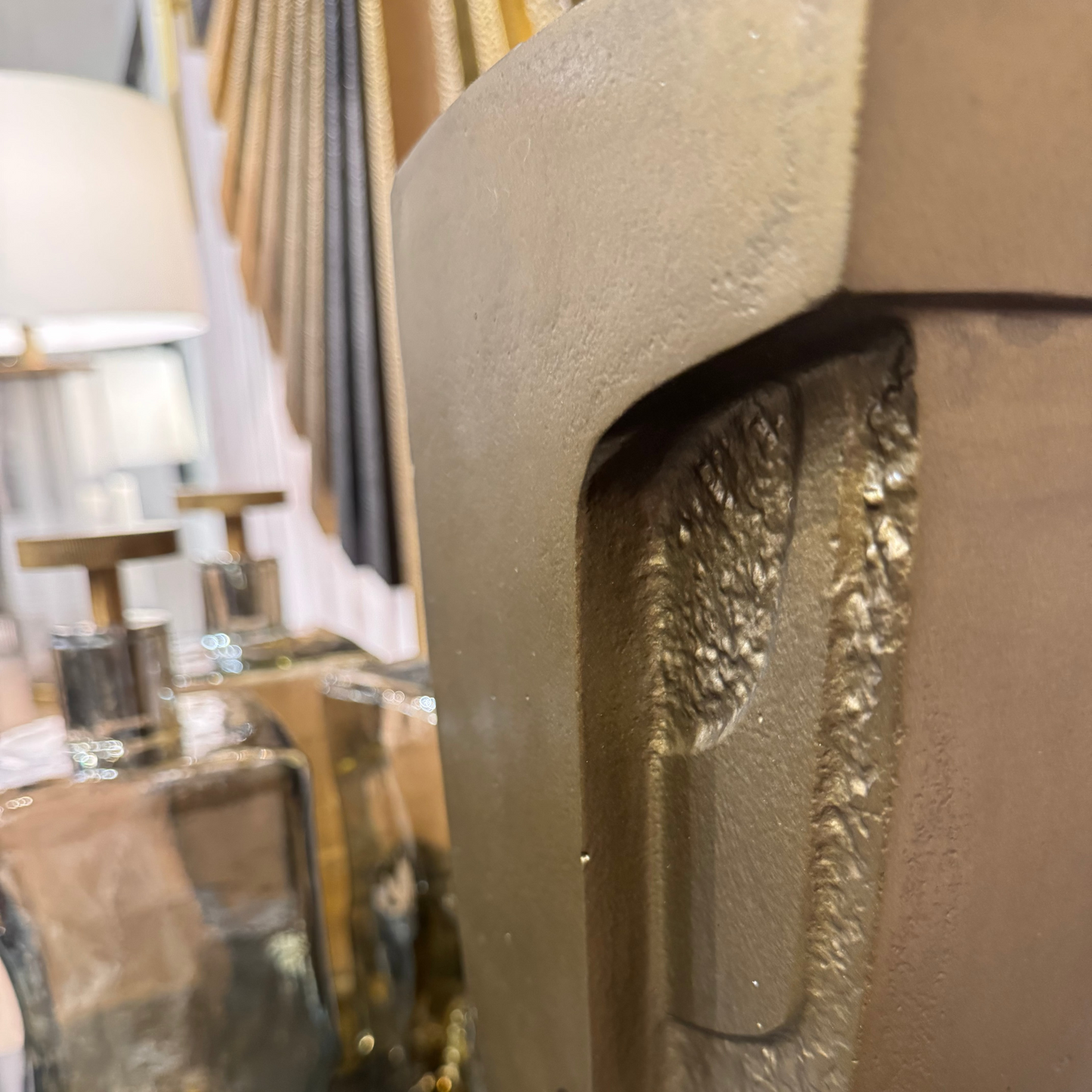 Close-up of a decorative metal with a textured surface, blurred background