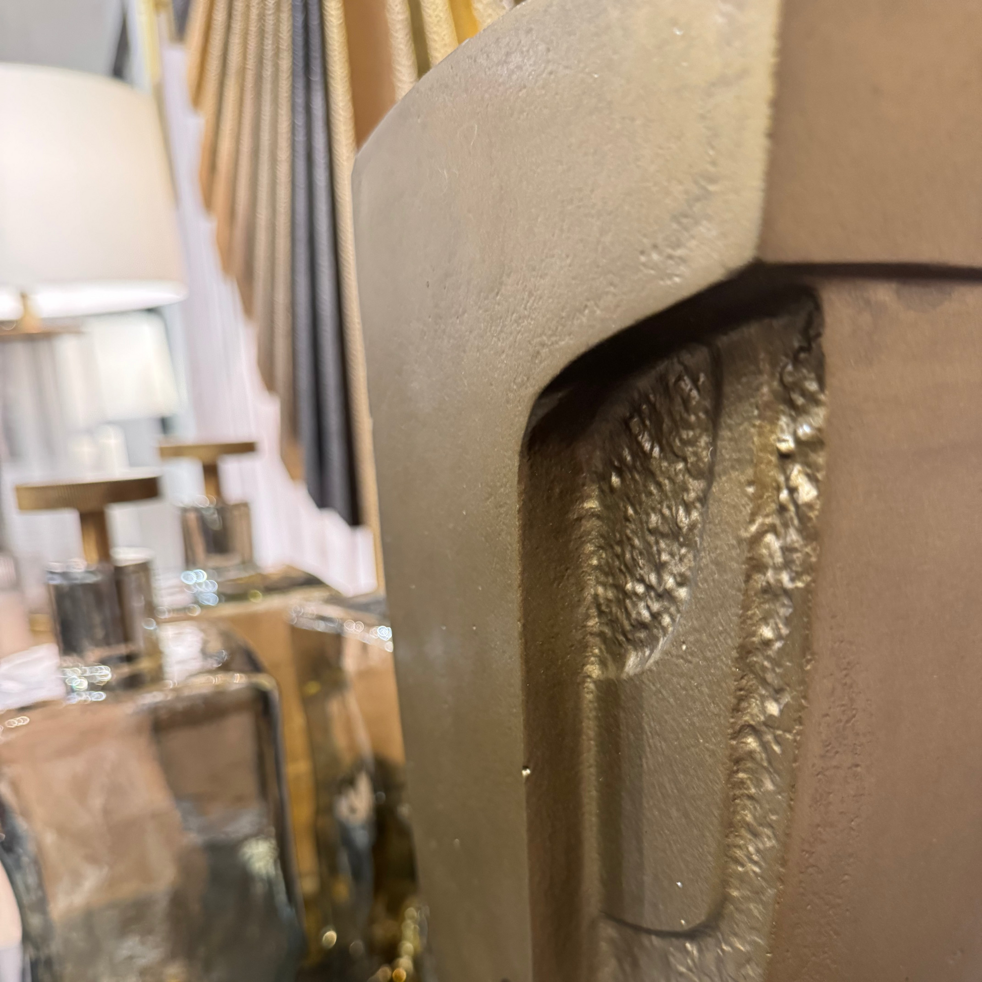 Close-up of a decorative metal with a textured surface, blurred background