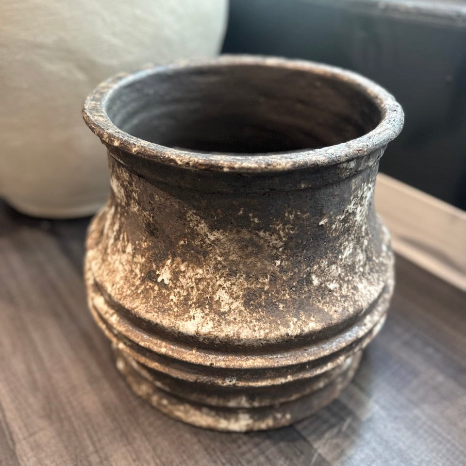 Vintage-style terracotta pot on a wooden surface