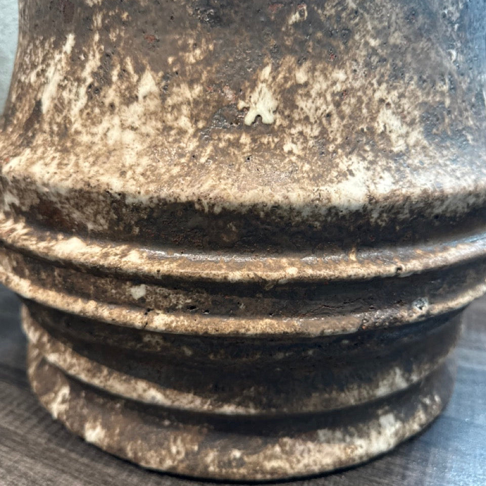 Close-up of a textured metal object on a gray surface